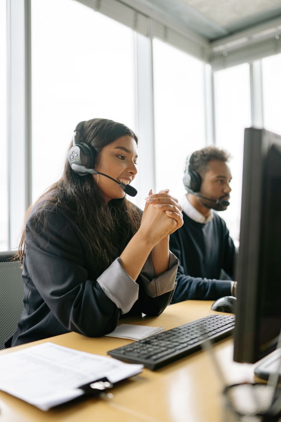 Customer service agent on a headset handling a business helpline call
